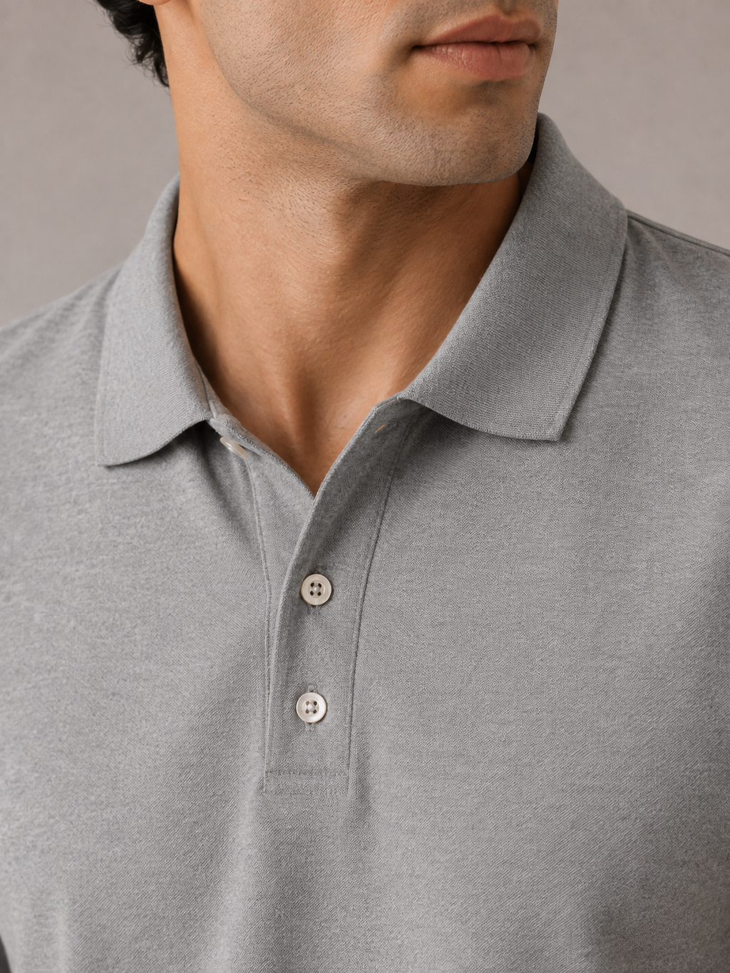 Men’s light grey Airtex polo shirt, back view on model, clean minimal shoulder line and drape