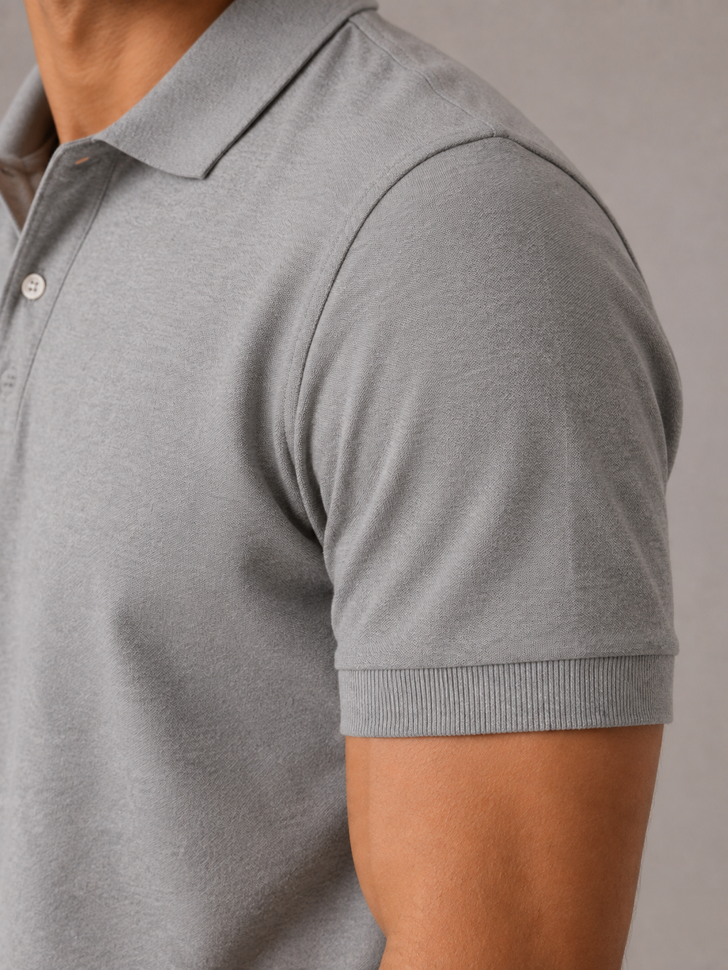 Men’s melange grey polo shirt, close-up view, textured cotton piqué fabric and button placket