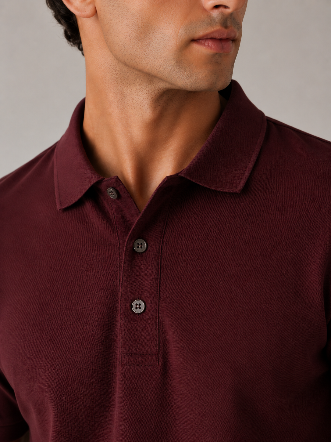 Men’s maroon piqué polo shirt, close-up detail view, dense Cotton Airtex knit and button placket